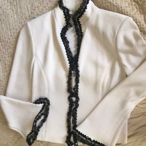 Cream jacket, flared at wrists. Excellent cond